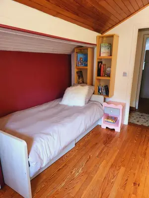 a bedroom with a large bed with a wooden floor at Les Balcons du Mont-Blanc : Appartement centre village in Cordon