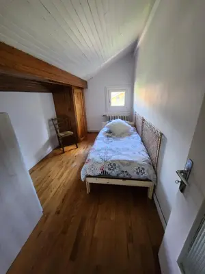 a small bedroom with a bed in a room at Les Balcons du Mont-Blanc : Appartement centre village in Cordon