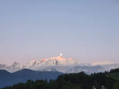 a snow covered mountain in the middle of a forest at Les Balcons du Mont-Blanc : Appartement centre village in Cordon