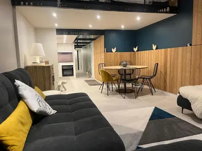 a living room with a couch and a table at Flaine Forum G1 Cassiopée Mezzanine & Terrasse in Flaine