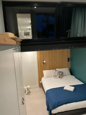 a small bedroom with a bed and a mirror at Flaine Forum G1 Cassiopée Mezzanine & Terrasse in Flaine