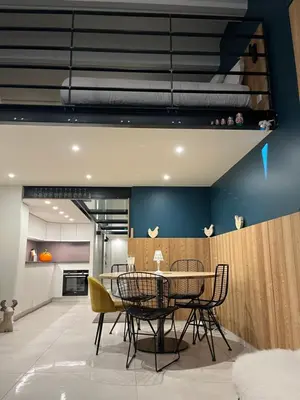 a dining room with a table and chairs at Flaine Forum G1 Cassiopée Mezzanine & Terrasse in Flaine
