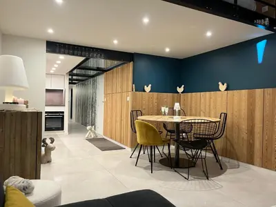a dining room with a table and chairs at Flaine Forum G1 Cassiopée Mezzanine & Terrasse in Flaine