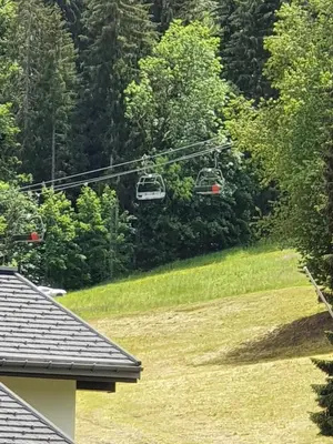 a couple of chairs on a ski lift over a yard at Praz des Esserts - 43 - Appt pied pistes - 6 pers in Morillon
