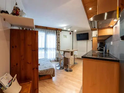 a room with a kitchen and a table in a room at Praz des Esserts - 43 - Appt pied pistes - 6 pers in Morillon