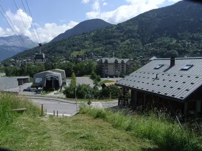 a group of people sitting at tables outside a building at Le Grand Panorama No11 in Saint-Gervais-les-Bains