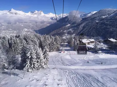 a ski resort covered in snow with a ski lift at Le Grand Panorama No11 in Saint-Gervais-les-Bains