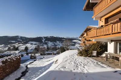 a snow covered road next to a building at Appartement Solaris - Magnificent views and great exposure! in Megève