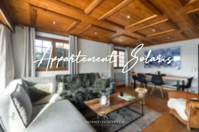 a living room with a couch and a table at Appartement Solaris - Magnificent views and great exposure! in Megève