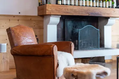 a living room with two chairs and a fireplace at Appartement Solaris - Magnificent views and great exposure! in Megève