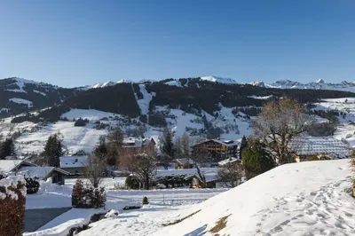 a town covered in snow with mountains in the background at Appartement Solaris - Magnificent views and great exposure! in Megève