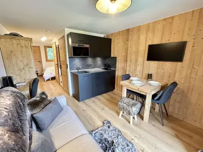 a living room with a couch and a table at Charmant studio avec balcon exposé sud, casier à skis et parking, proche des pistes à Demi-Quartier - FR-1-597-175 in Demi-Quartier