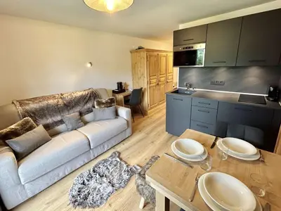 a living room with a couch and a table at Charmant studio avec balcon exposé sud, casier à skis et parking, proche des pistes à Demi-Quartier - FR-1-597-175 in Demi-Quartier