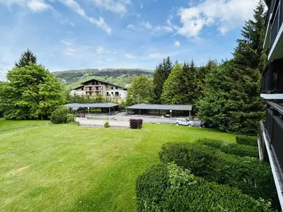 a large yard with a building and a car in the background at Charmant studio avec balcon exposé sud, casier à skis et parking, proche des pistes à Demi-Quartier - FR-1-597-175 in Demi-Quartier