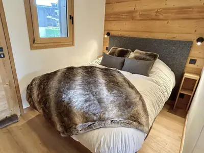 a bedroom with a bed with a blanket on it at Charmant studio avec balcon exposé sud, casier à skis et parking, proche des pistes à Demi-Quartier - FR-1-597-175 in Demi-Quartier