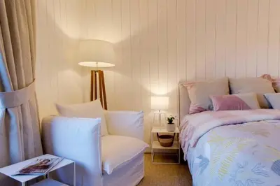 a bedroom with a bed and a chair and a lamp at Luxury Studio - Mountain View & 100m to Slopes - Near Chamonix in Les Houches