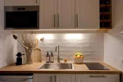 a kitchen counter with a sink and a bowl of fruit at Luxury Studio - Mountain View & 100m to Slopes - Near Chamonix in Les Houches