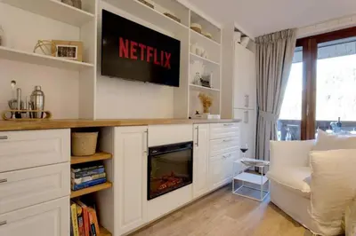 a living room with a tv and a fireplace at Luxury Studio - Mountain View & 100m to Slopes - Near Chamonix in Les Houches