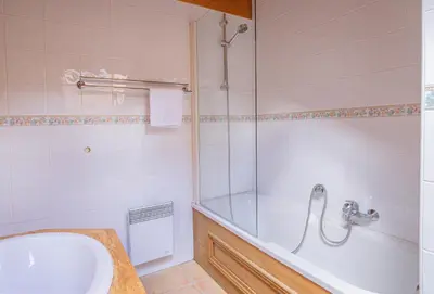 a bathroom with a tub and a sink at Apartment Capucin - A 3 Bedroom Chamonix Mountain Loft in Chamonix-Mont-Blanc