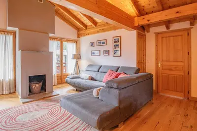 a living room with a couch and a fireplace at Apartment Capucin - A 3 Bedroom Chamonix Mountain Loft in Chamonix-Mont-Blanc