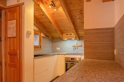 a kitchen with wooden ceilings and a counter top at Apartment Capucin - A 3 Bedroom Chamonix Mountain Loft in Chamonix-Mont-Blanc