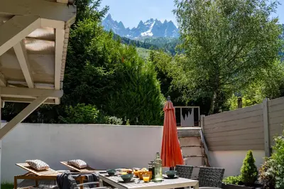 a patio with a table and an umbrella at Aiguille 1 in Chamonix-Mont-Blanc
