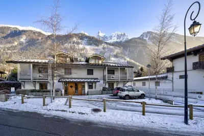 a house with a car parked in the snow at Aiguille 1 in Chamonix-Mont-Blanc