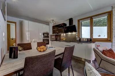 a kitchen and dining room with a table and chairs at Aiguille 1 in Chamonix-Mont-Blanc