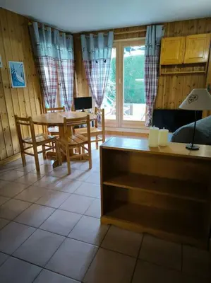 a living room with a table and a dining room at Appartement à 50m des remontées in Saint-Gervais-les-Bains