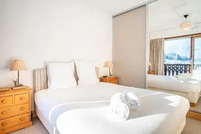 a bedroom with two beds and a window at Le Savoy 2 - Pied des pistes - Centre in Chamonix-Mont-Blanc