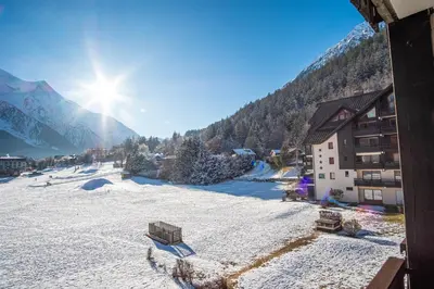 a view of a snow covered ski slope with a building at Le Savoy 2 - Pied des pistes - Centre in Chamonix-Mont-Blanc
