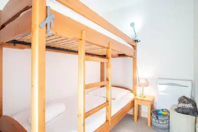 a bunk bed in a room with a ladder at Le Savoy 2 - Pied des pistes - Centre in Chamonix-Mont-Blanc
