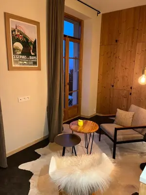 a living room with a couch and a table at un nid avec balcon in Saint-Gervais-les-Bains