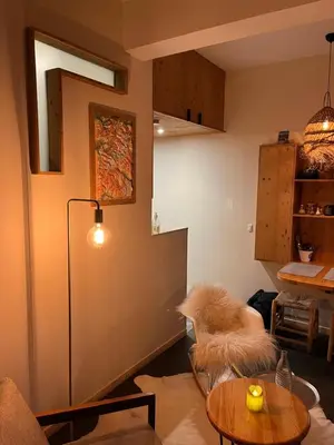 a living room with a couch and a table at un nid avec balcon in Saint-Gervais-les-Bains