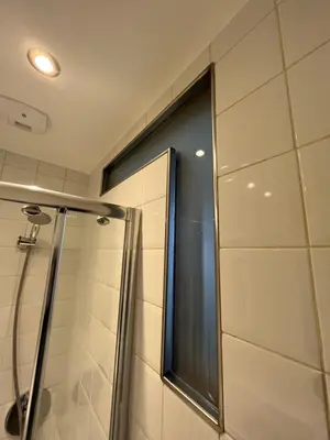 a shower with a glass door in a bathroom at un nid avec balcon in Saint-Gervais-les-Bains
