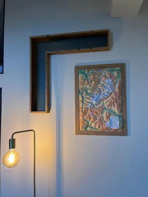 a door with a painting on the wall next to a lamp at un nid avec balcon in Saint-Gervais-les-Bains