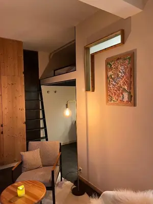 a living room with a couch a chair and a table at un nid avec balcon in Saint-Gervais-les-Bains