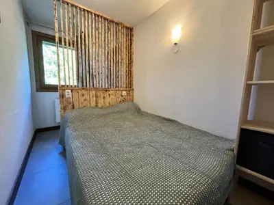 a small bedroom with a bed and a window at Appartement rénové avec piscine à Samoëns - FR-1-624-151 in Samoëns