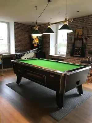 a living room with a pool table in a room at Maison Sallanches 12 couchages in Sallanches