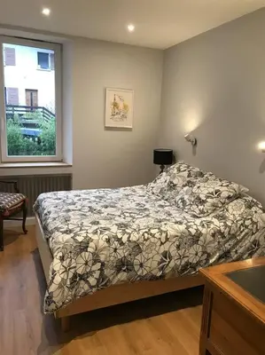 a bedroom with a bed and a window at Maison Sallanches 12 couchages in Sallanches