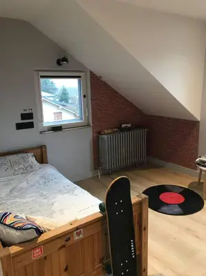 a bedroom with a bed and a skateboard in it at Maison Sallanches 12 couchages in Sallanches