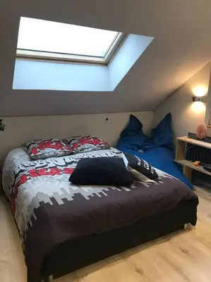 a bedroom with a bed with blue pillows on it at Maison Sallanches 12 couchages in Sallanches