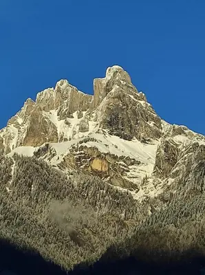 a large rocky mountain with snow on it at Maison Sallanches 12 couchages in Sallanches