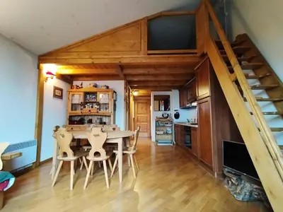 a kitchen and dining room with a table and a staircase at Résidence Aigle Royal - L'Aigle Royal MAE-7671 in Les Houches