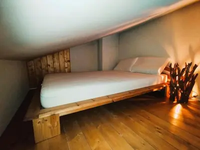 a bed in a room with a wooden frame at Résidence Aigle Royal - L'Aigle Royal MAE-7671 in Les Houches