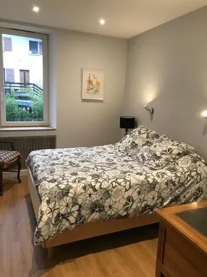 a bedroom with a bed and a window at Chambre Sallanches in Sallanches