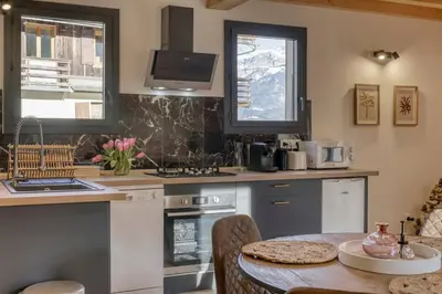 a kitchen with a table and a counter top at chalet Louis situé 25 km Chamonix in Saint-Gervais-les-Bains