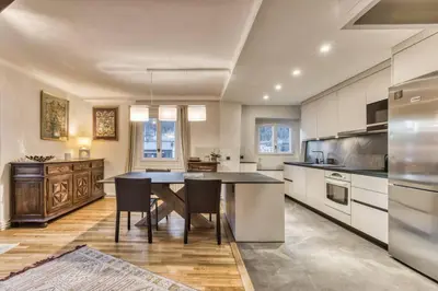 a large kitchen with a table and chairs in it at Nouveau ! spacieux 100 m², hyper centre Chamonix in Chamonix-Mont-Blanc