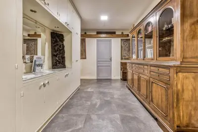 a large kitchen with wooden cabinets and tile floors at Nouveau ! spacieux 100 m², hyper centre Chamonix in Chamonix-Mont-Blanc