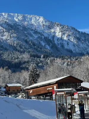 a ski lodge with a snow covered mountain in the background at Apartement vue Monblanc incroyable ski inout Prarion5 in Les Houches